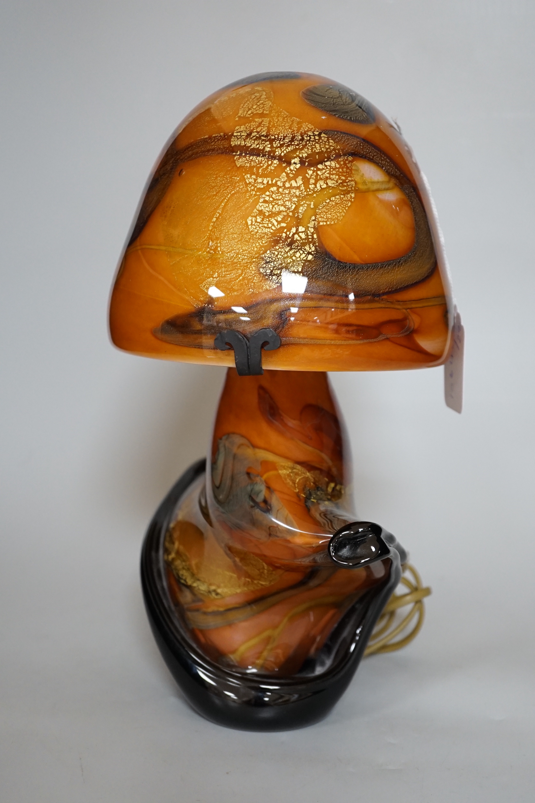 An indistinctly signed multi coloured art glass mushroom shaped table lamp, 35cm high